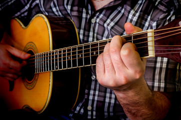Fototapeta na wymiar Man playing acoustic guitar