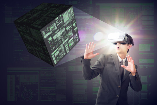 Smart business man in very exciting mood with VR headset with digital cube on digital background. Head-up Display concept.
