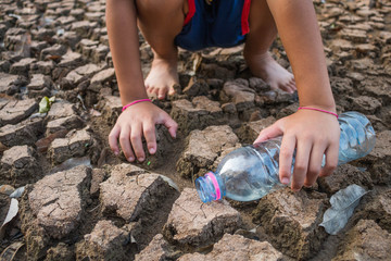 Children pour water on the arid ground, Drought concept.