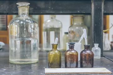 detail shot of beakers and equipment on table in factory laboratory.