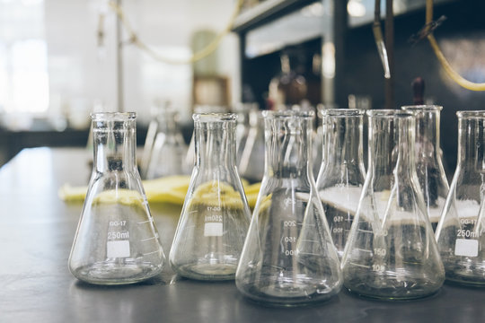 detail shot of beakers and equipment on table in factory laboratory.