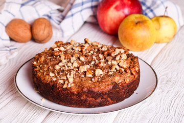 homemade apple pie with nuts on a plate, horizontal