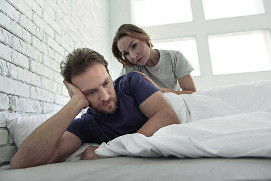Upset couple lying in bed