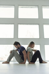 Fototapeta premium Frustrated couple sitting near window