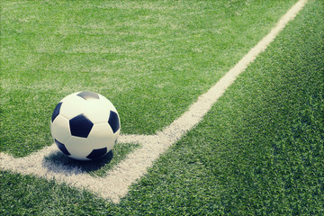 Fototapeta na wymiar Ball on conner in Soccer football field stadium