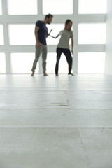 Despaired married couple standing in room