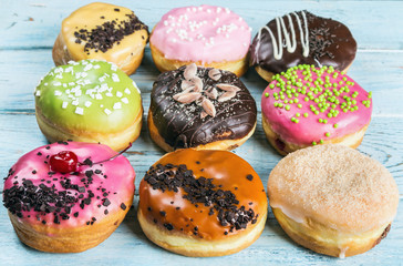 fresh baked glazed donuts on a blue wooden table