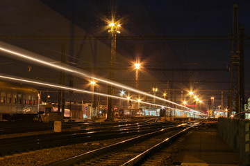 Fototapeta na wymiar Train with strong light on long exposure in main station.