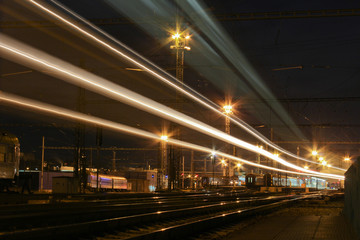 Fototapeta na wymiar Train with strong light on long exposure in main station at night scene.