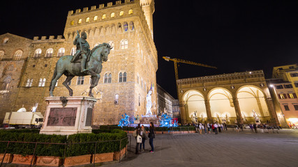 Tourists in Piazza della Signoria, the famous square in front of Old Palace (Palazzo Vecchio)  in Florence, Tuscany, Italy