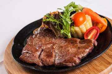 grilled sirloin steak with vegetables and noodles