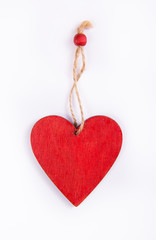 Red heart made of wood. Wooden pendant in the shape of heart.