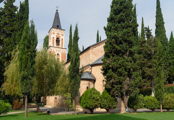 Fototapeta na wymiar Bell tower and St. George's church in Monastery of St. Nino at Bodbe. Sighnaghi. Georgia