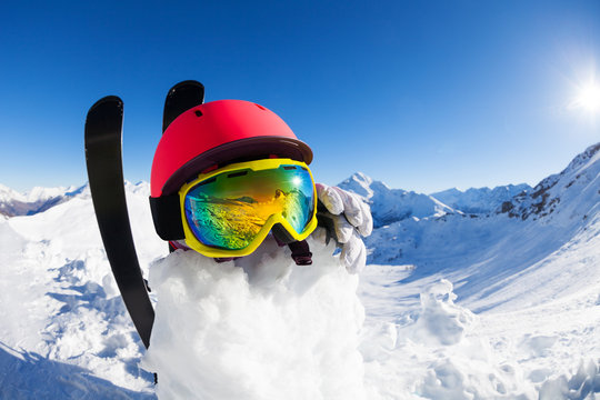 Funny snowman wearing safety helmet and mask