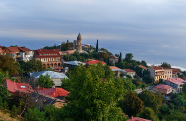 Fototapeta na wymiar View of houses and old church in Signagi or Sighnaghi city. Georgia