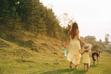Obraz premium mother walk with his little daughter, and their dog