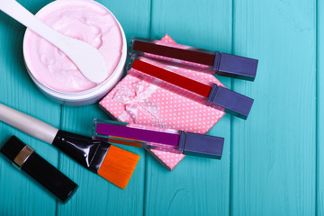 Naklejka premium various cosmetics: cream, lipsticks, brush, cosmetic spatula, present box