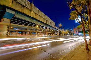 Cityscape of light trails with blurred colors on the street at night