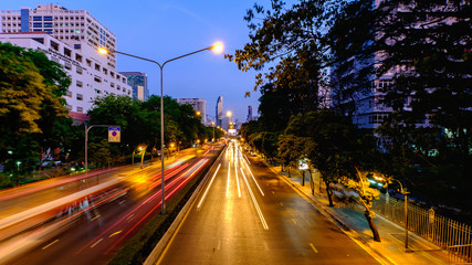 Cityscape of light trails with blurred colors on the street at night.