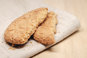 Pastry biscuits on linen napkin on wooden table
