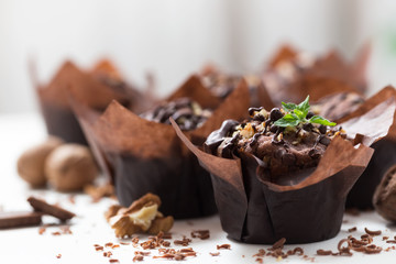 Chocolate muffins with walnut, homemade bakery, close up, selective focus