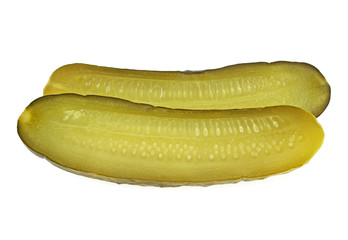 One pickled cucumber cut in half on white background