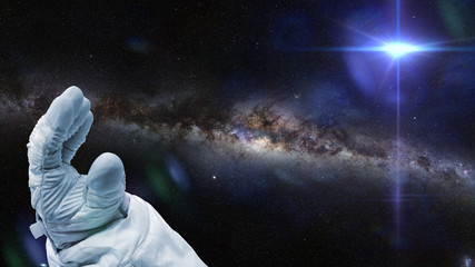 Fototapeta premium astronaut, bright nearby star and the local a galaxy