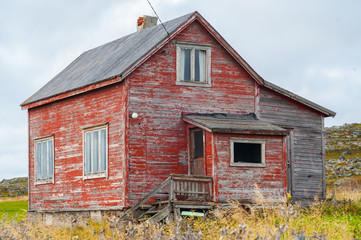 Fototapeta na wymiar Weathered old wooden country house in need of repair