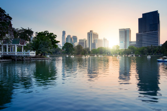 Lumpini park with Bangkok office building city skyline.