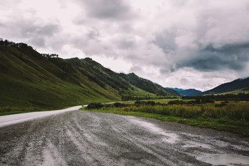 Naklejka premium Landscape with green mountains, roads, sky