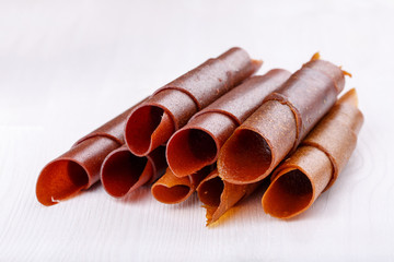 Apple and plum fruit leather rolls. Fruit candy - pastille.