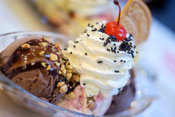 Chocolate and Strawberry Cheese ice cream with Whipping Cream and Cherry.