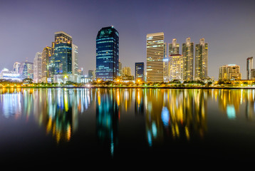 City downtown at night with reflection of skyline.