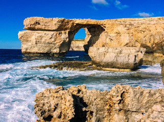Azure Window, famous stone arch of Gozo island in the sun in summer, Malta.