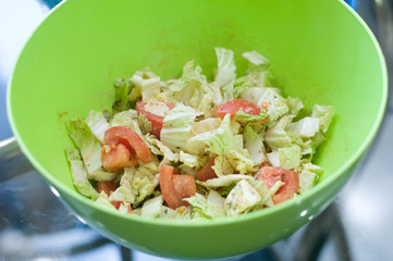 Greek salad in green bowl