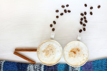 fantastic coffee cruise for two persons/ A pair of coffee cups with frothy cappuccino portray a steamer