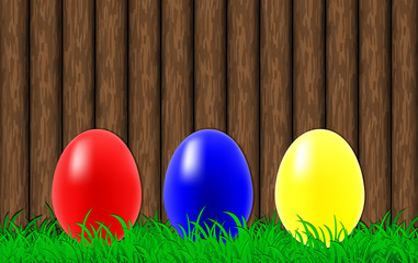 Easter eggs on a wooden wall background