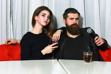 Romantic couple of pretty girl and bearded man at karaoke