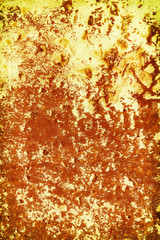 An old rusty wall with stains. Yellow and red