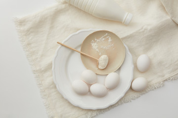 Raw eggs and spoon of flour