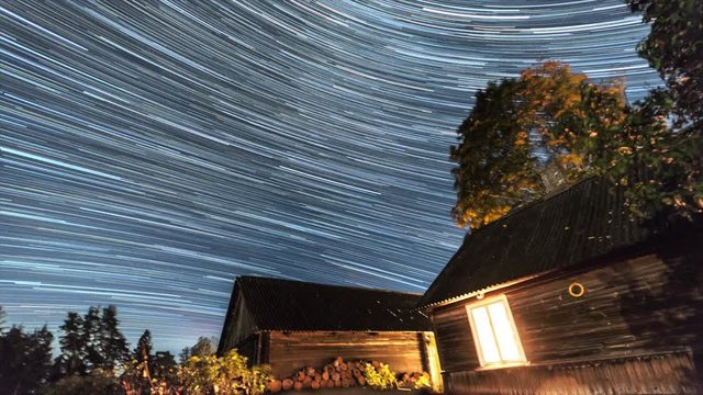 Star Trails Night Sky Cosmos Galaxy Time-lapse over old village. Amazing high resolution night lapse at Tudulinna, Estonia. Nature landscape.