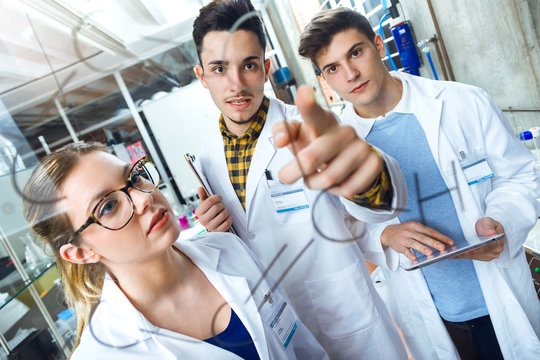 Young scientists carrying out an experiment in a laboratory.