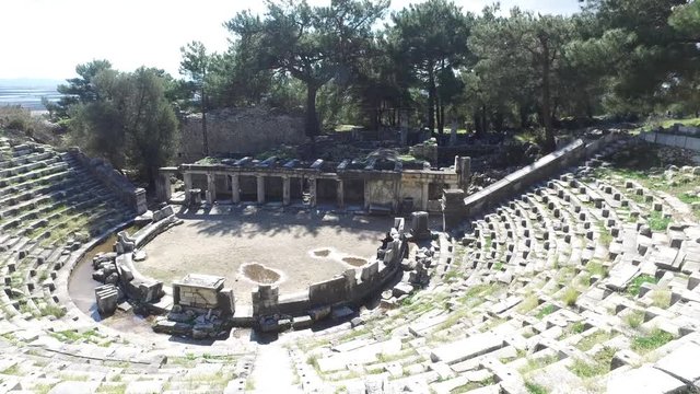 General temple and amphitheater view of Priene Ancient City in Aydın, Turkey, on bright blue sky background.