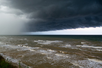Storm front over water with wall of rain