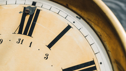 Close-up of Roman numerals on the dial of the wall clock.