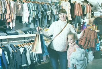 Positive pregnant mother and girl enjoying purchases