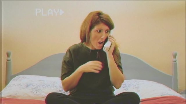 Fake VHS tape: a loghorreic young woman (talking with an excessive flow of words), in her bedroom, making a call with a 90s wireless phone. Timelapse.
