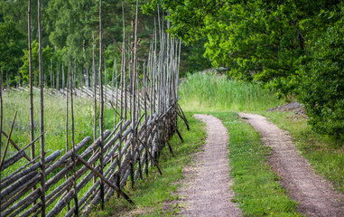 Roundpole fence along an old path