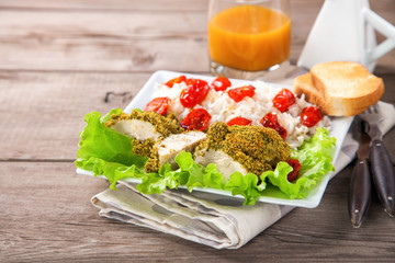 Chicken fillet in a green breading with a garnish. Selective focus. Copy space.