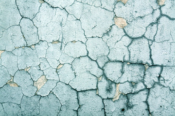 Cracked cyan toned cement wall texture.